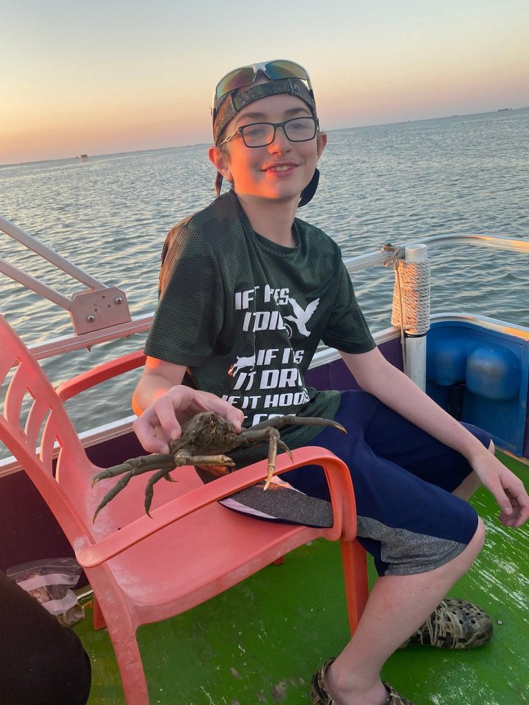 Boy holding fiddler crab